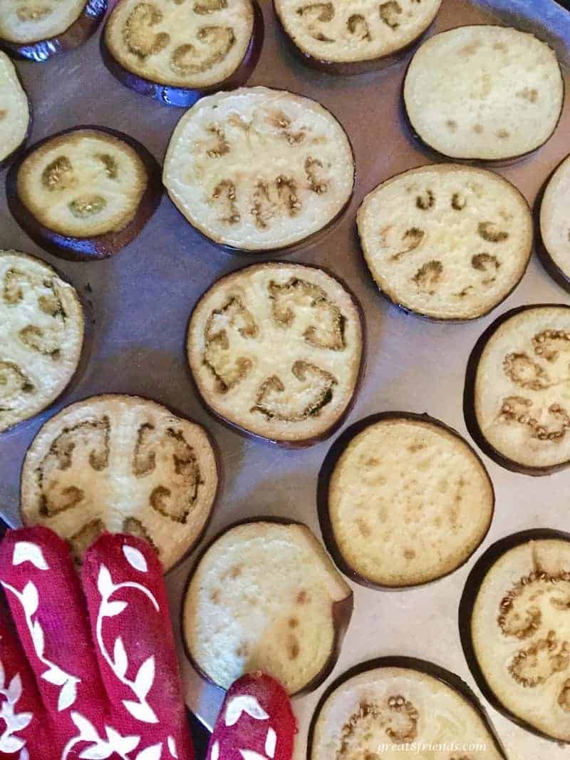 Slices of eggplant on a baking sheet.