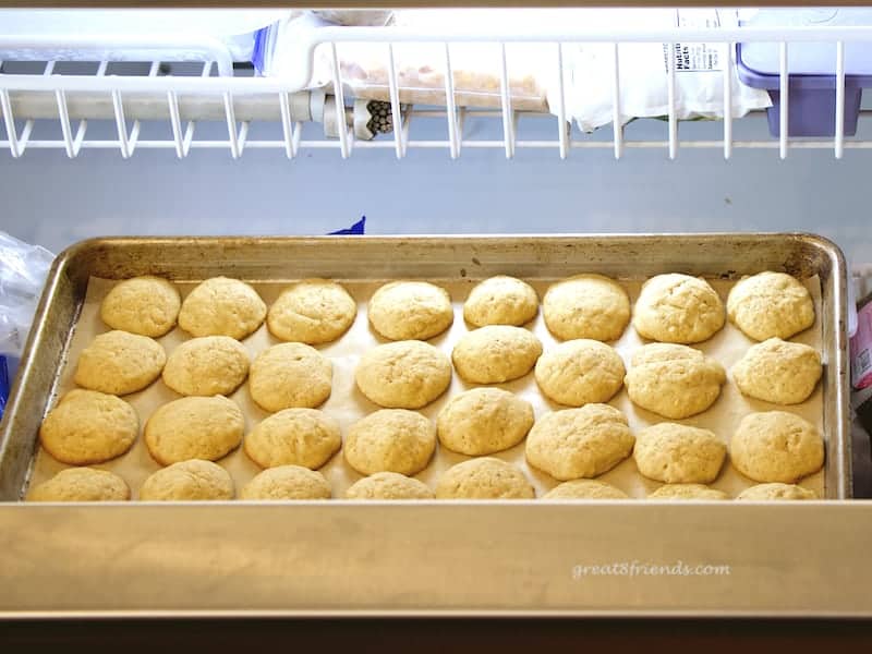 Cookies on parchment lined tray in freezer.