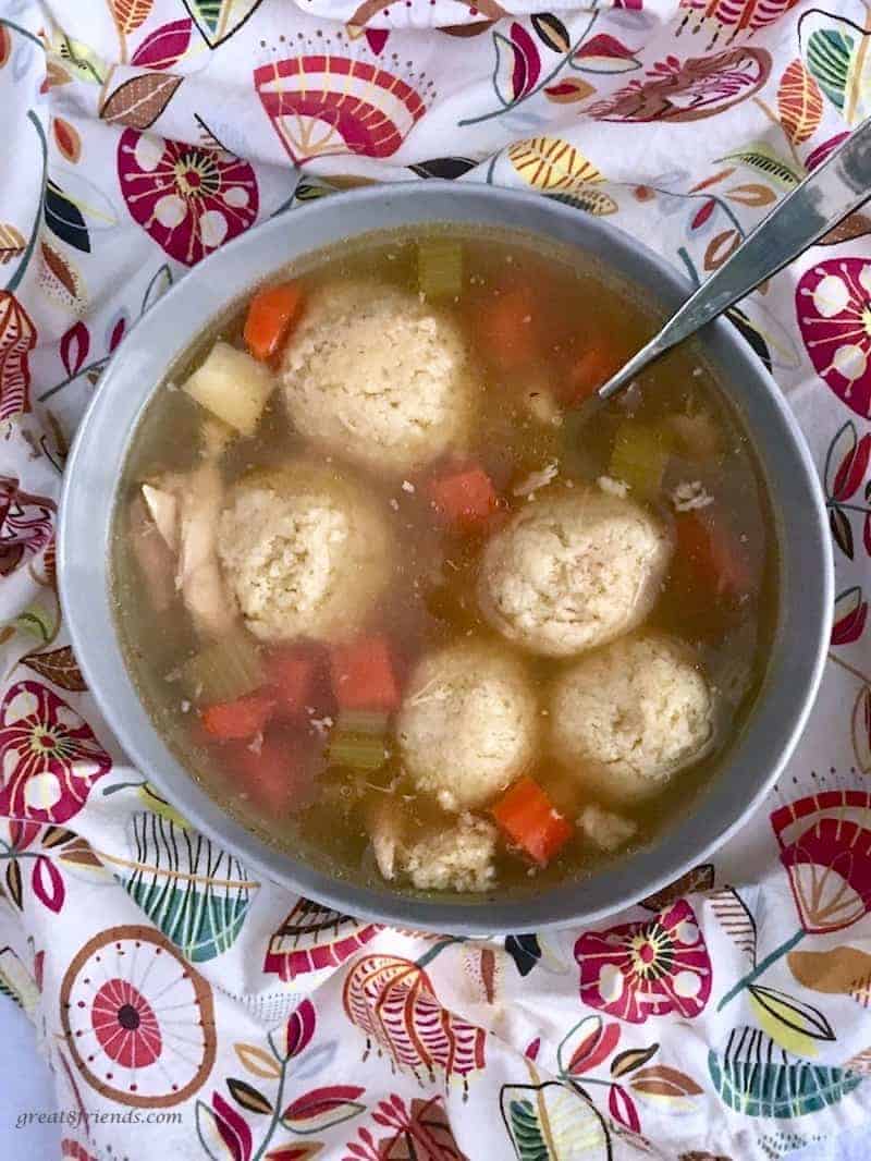 Overhead photo of a bowl of matzo ball soup.