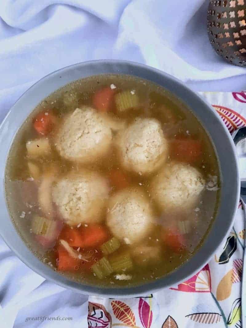 Overhead photo of a bowl of matzo ball soup.