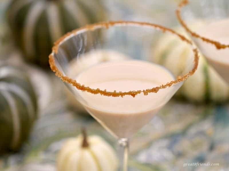 Upclose shot of a pumpkin martini with a caramel sugar rim.