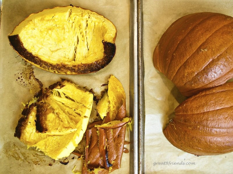 Pumpkins cut and roasted on baking sheets.