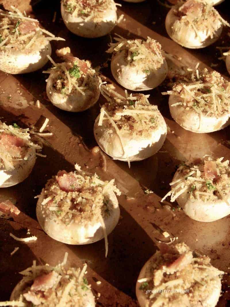 Prosciutto and Parmesan stuffed mushrooms on a baking sheet before baking.