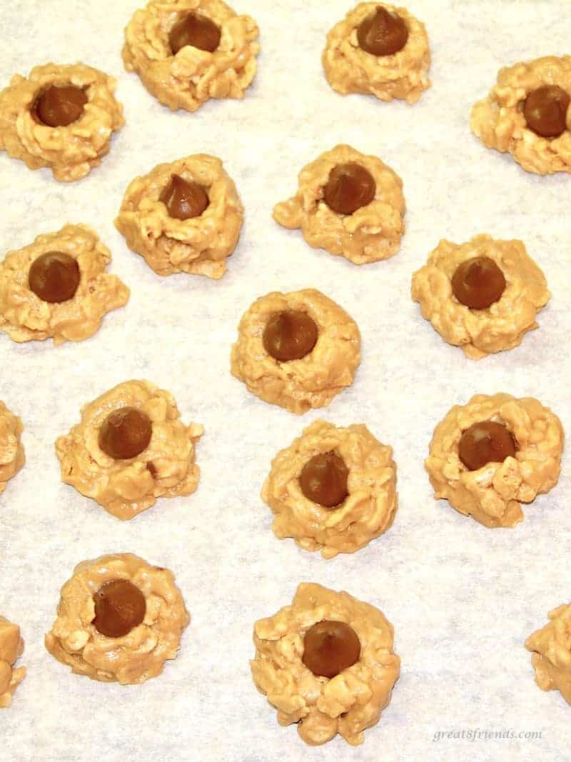 Cookie sheet of no bake Peanut Butter cereal cookies with Hershey's Kisses.