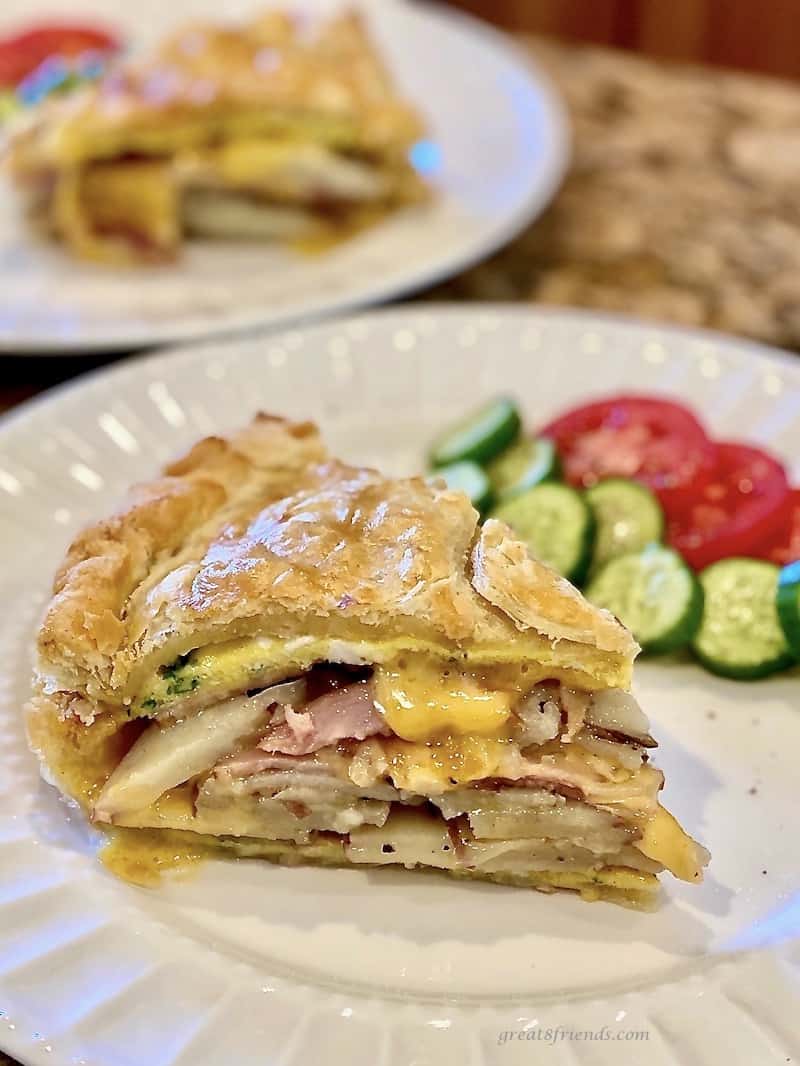 Cut piece of an egg, potato and ham brunch torte.