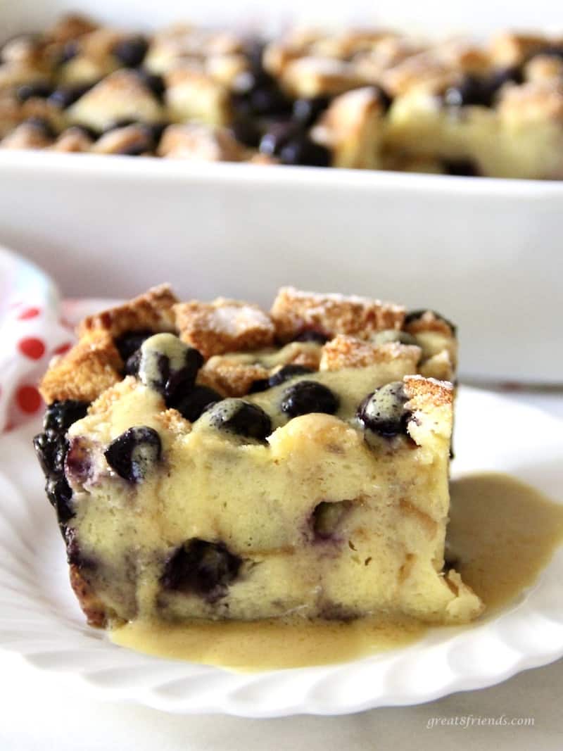A cut piece of delicious Blueberry Bread Pudding with Maple Bourbon Sauce.
