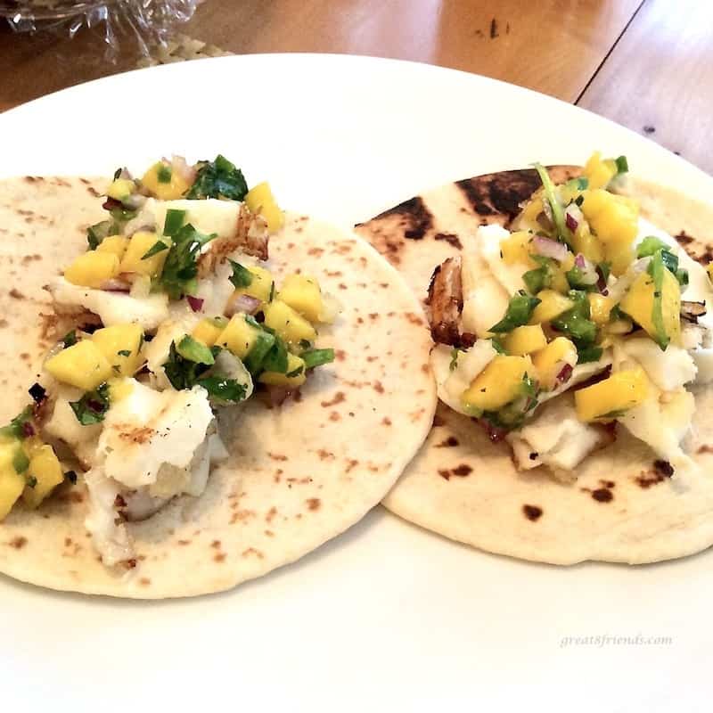 A couple grilled fish tacos with mango salsa is an easy supper.