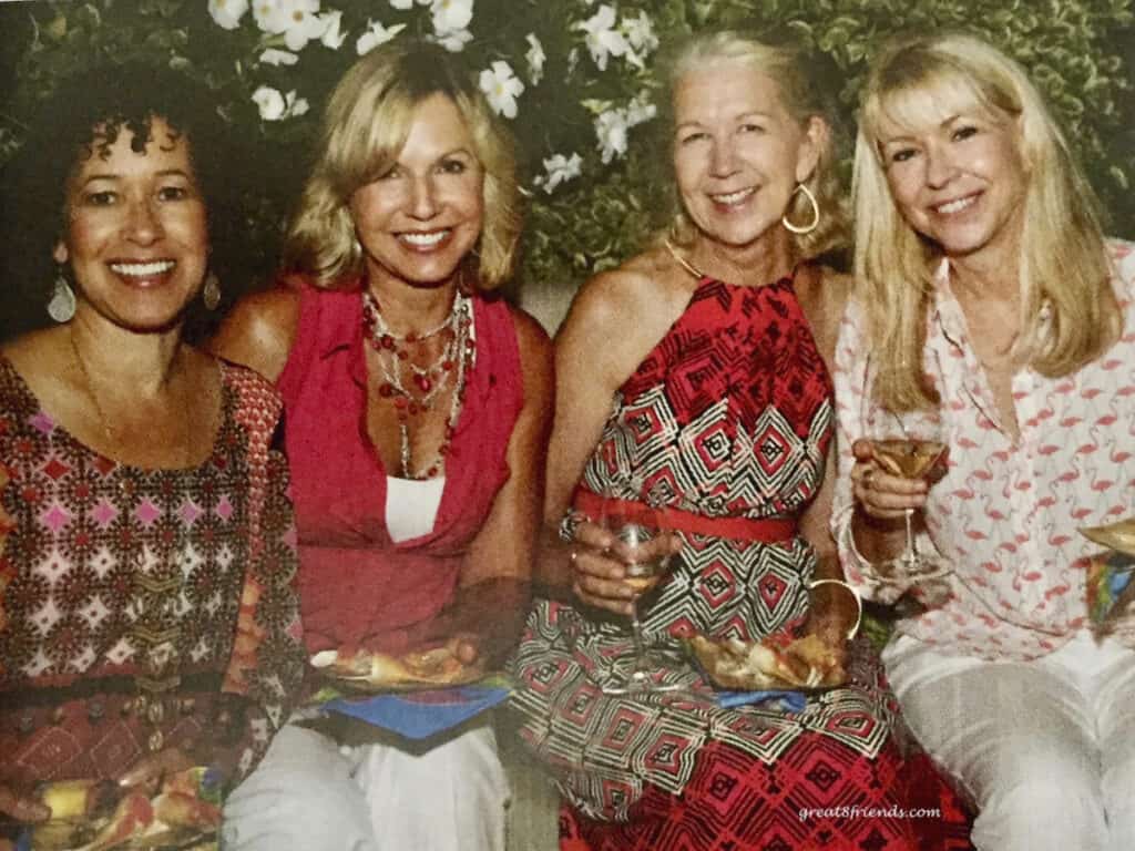 Four ladies in colorful dresses.