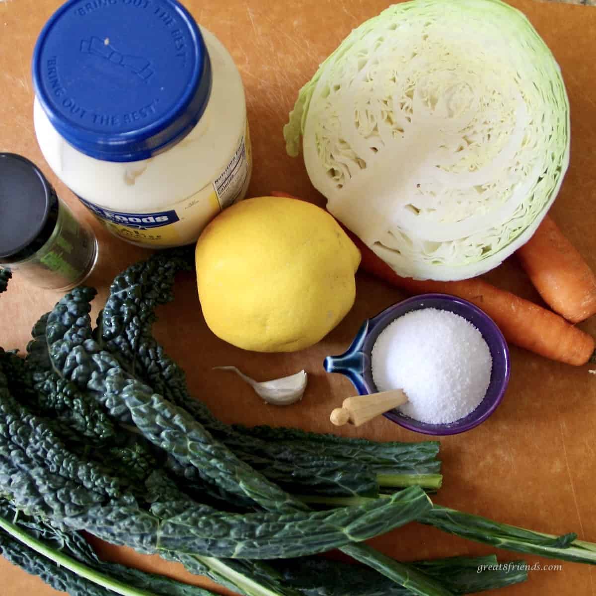 Ingredients to prepare a kale and cabbage slaw with a lemon aioli dressing.