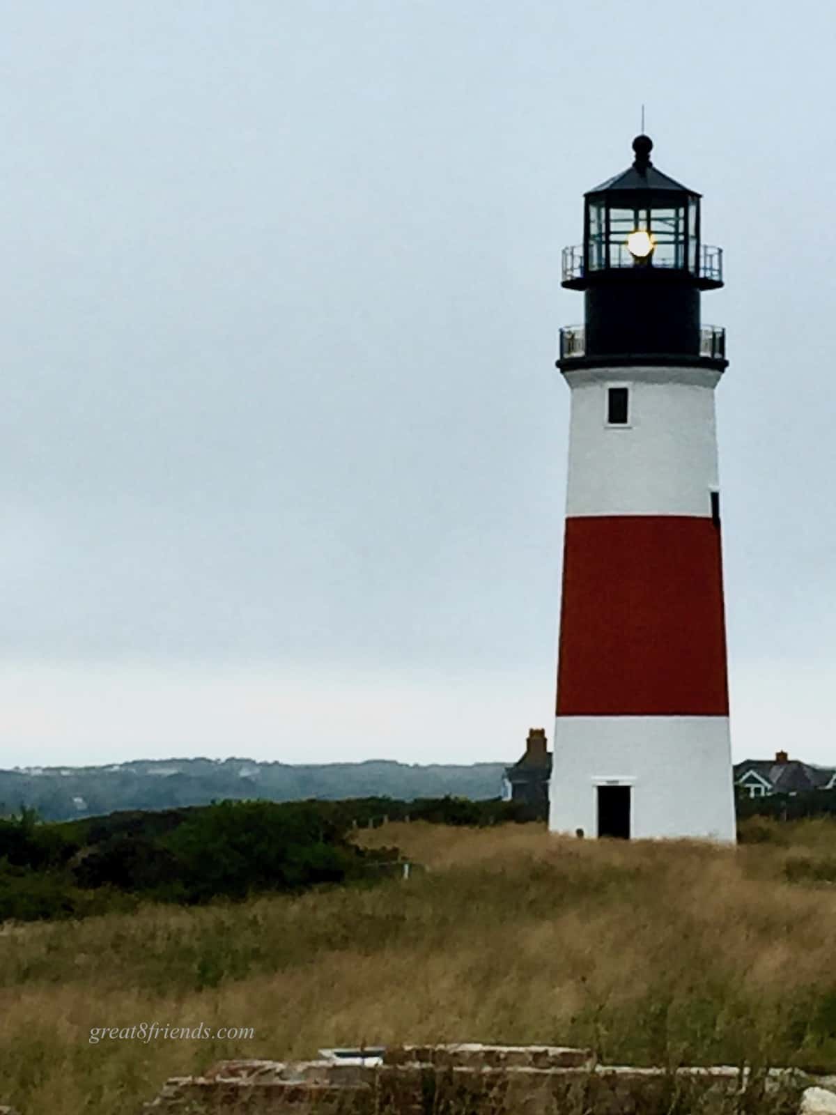 Lighthouse standing on a hill.