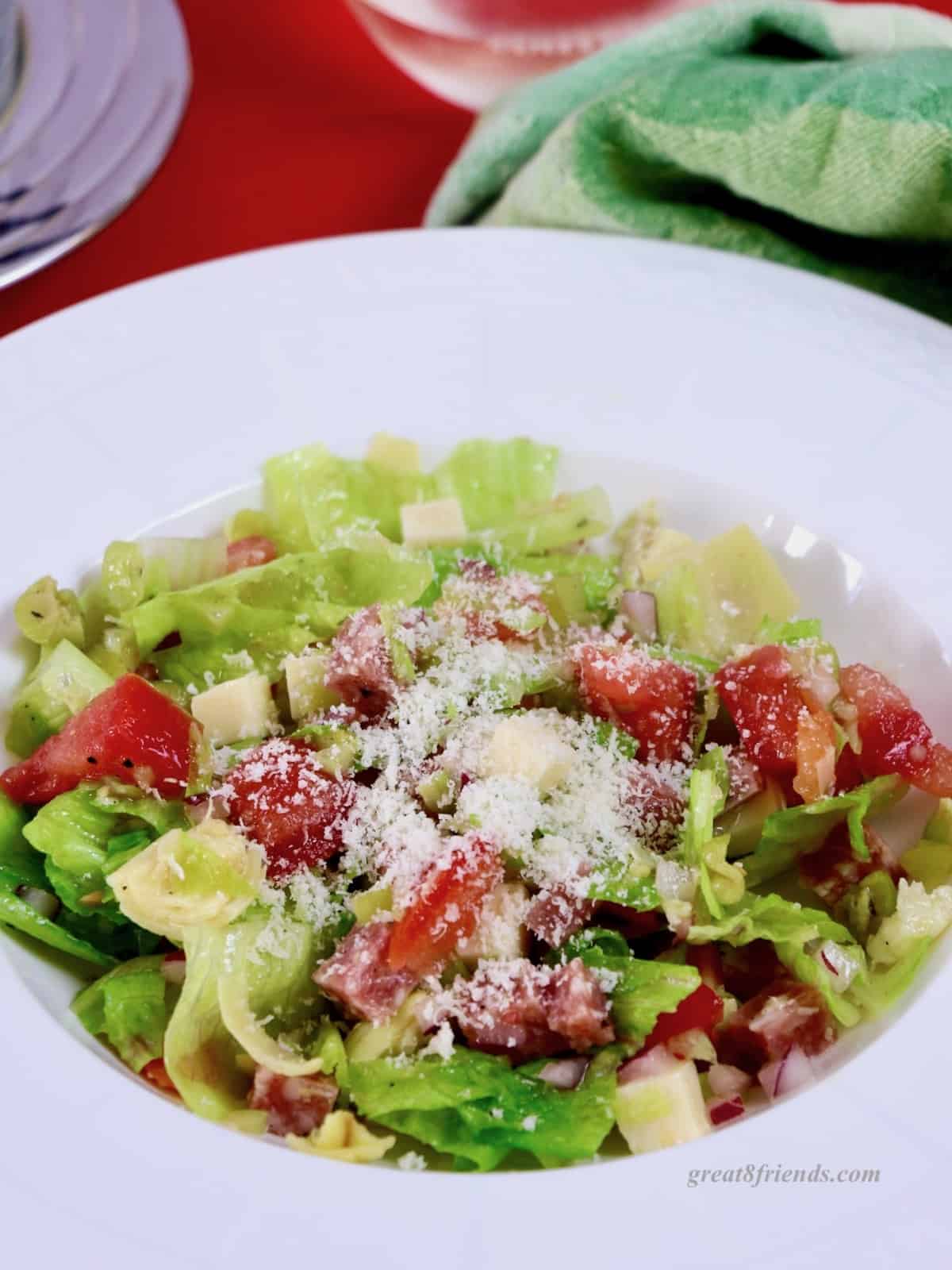 Chopped salad in a white rimmed bowl.