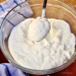 Glass bowl of homemade ricotta.