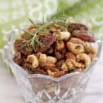 Rosemary spice nuts in a glass bowl.