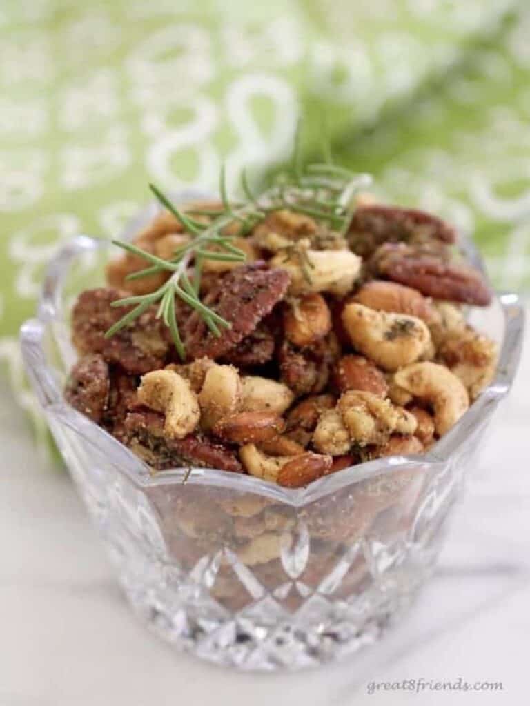 Rosemary spice nuts in a glass bowl.