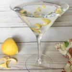 A martini with served with lemon peel as garnish in the glass.