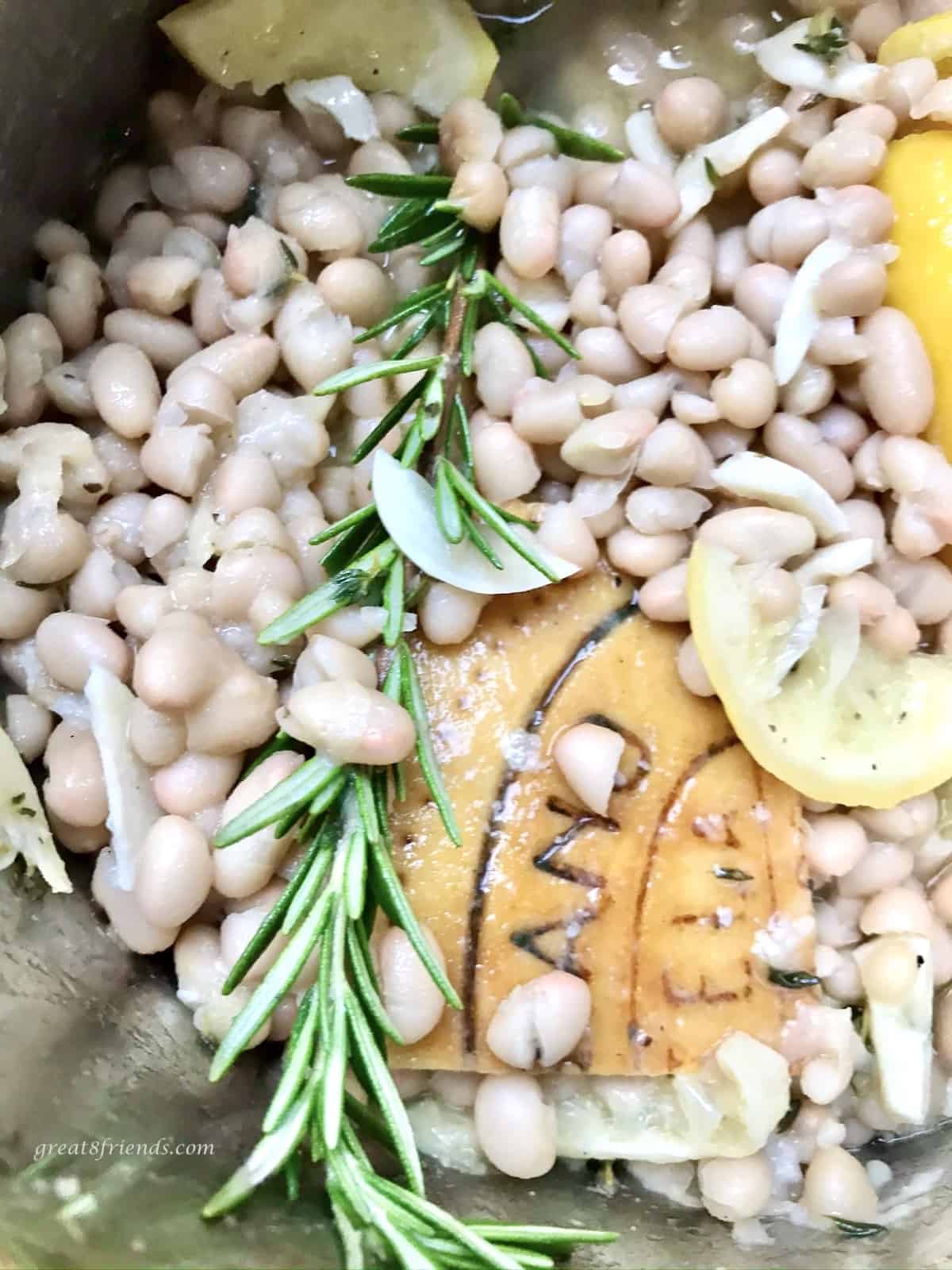 Pot of beans, rosemary and parmesan rind.