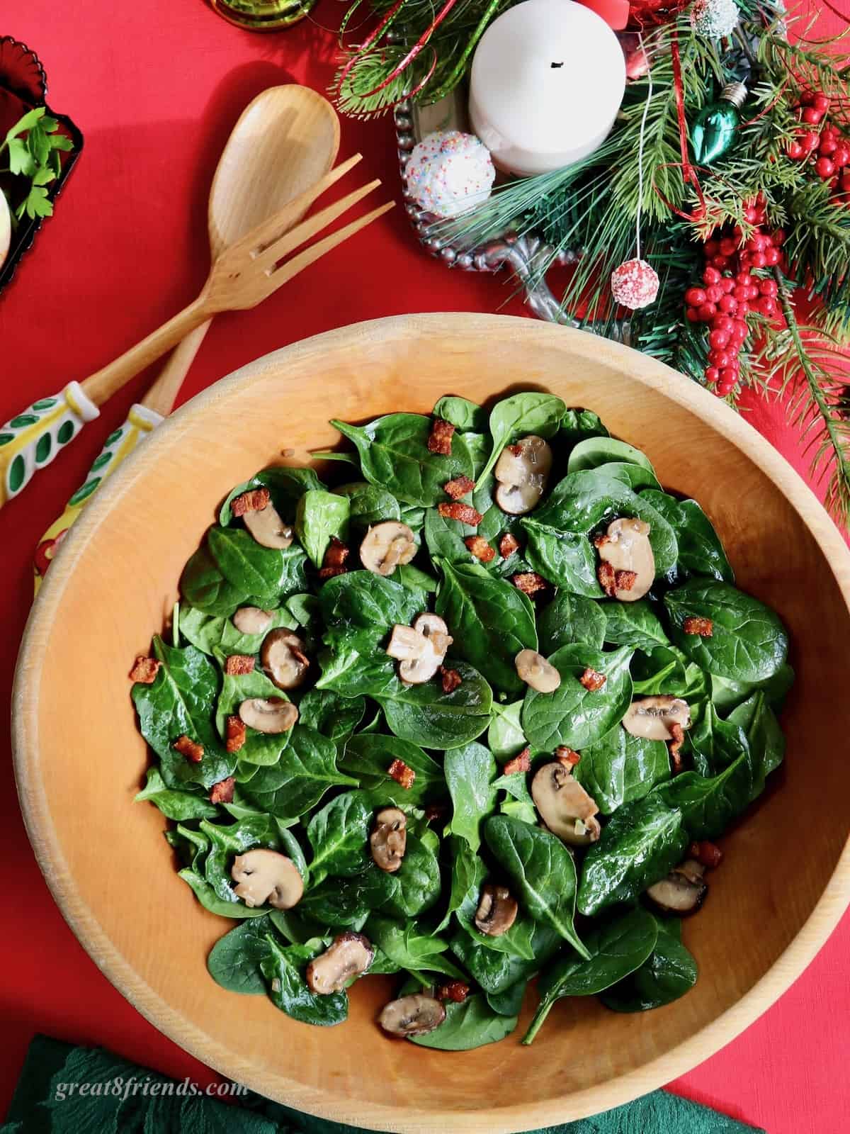 Spinach salad in a wooden bowl.