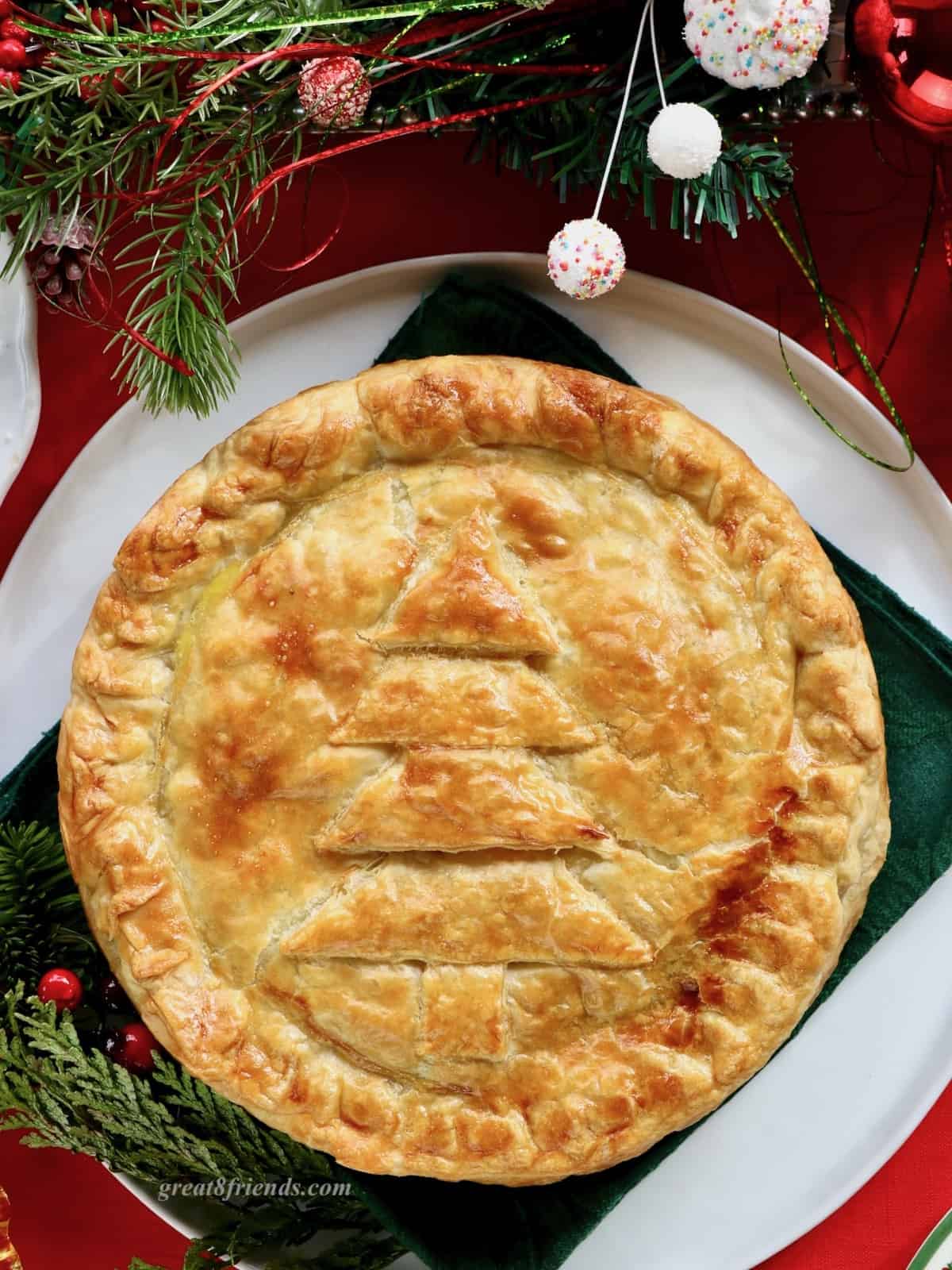 Overhead shot of brunch torte with a christmas tree in relief on the dough.