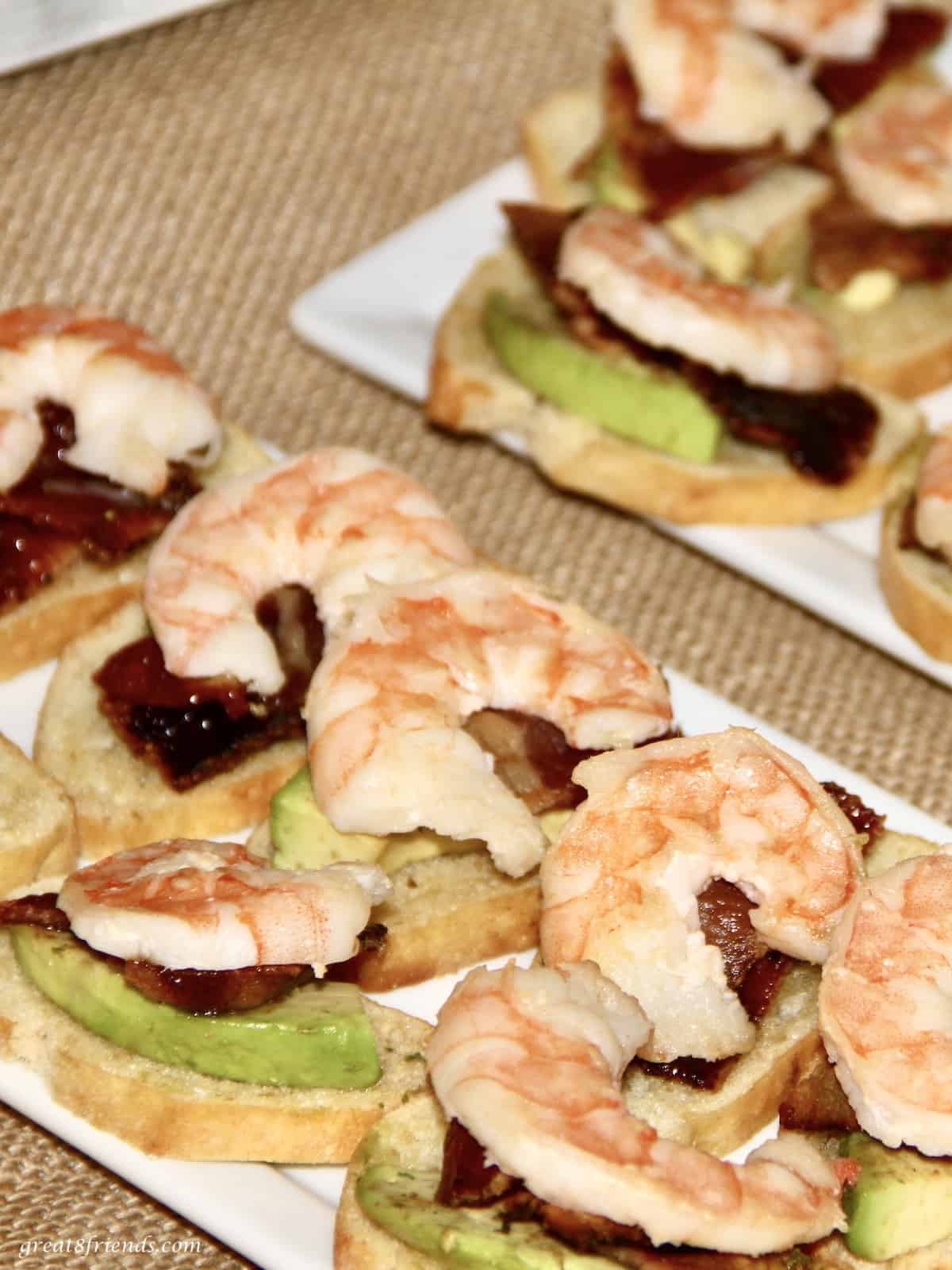 This hearty appetizer includes shrimp, candied bacon and avocado all on a toasted crostini.