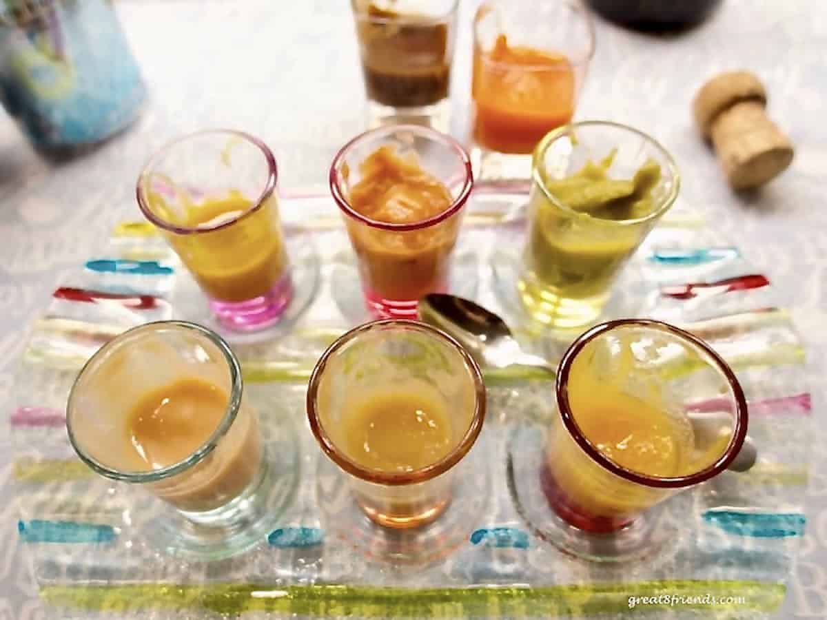 Several small glass containers with baby food in them.