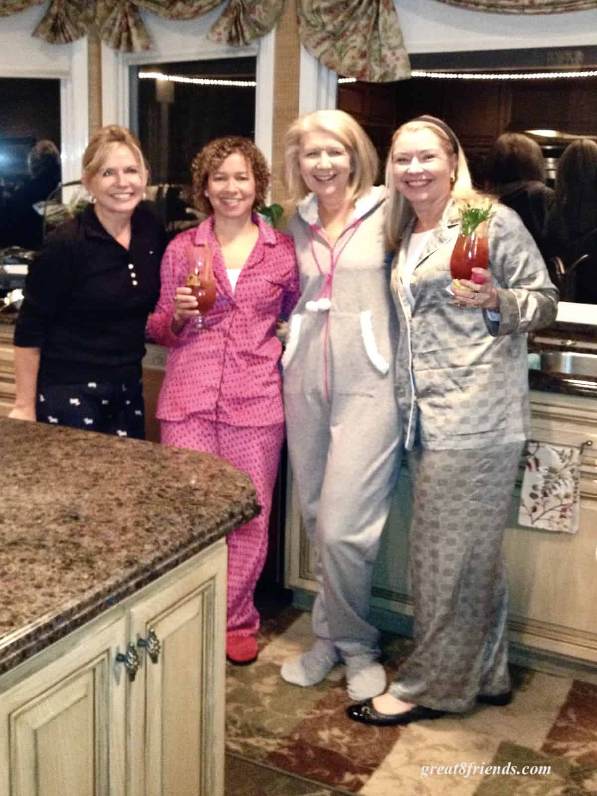 Four women posing in their pajamas.